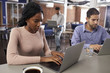© Monkey Business - Businesspeople Working On Laptops In Office Coffee Bar