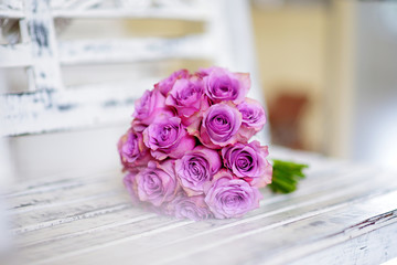 Beautiful pink bridal bouquet lying on white bench