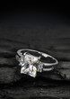 jewelry ring witht big diamond on dark coal background