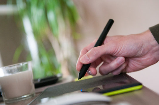 Graphic designer using a drawing graphics tablet