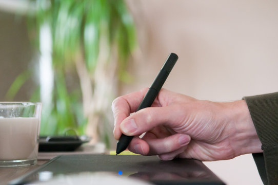 Graphic designer using a drawing graphics tablet