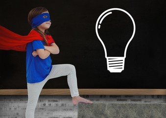 Canvas Print - kid and blackboard with lightbulb against a black background