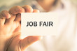 © stanciuc - Businessman holding JOB FAIR message card