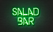 Salad bar neon sign on brick wall background.
