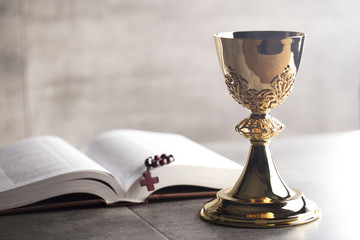 chalice, bible and altar cross.