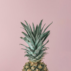 Ripe pineapple close up on pink pastel background. Minimal fruit concept.