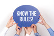 © relif - Group of people holding the KNOW THE RULES! written speech bubble