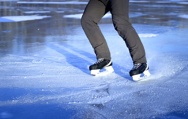 Wall Mural - The guy rides on skates on ice in the winter.