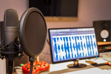 Wall Mural - condenser microphone in digital recording, editing, broadcasting, podcast or online radio studio