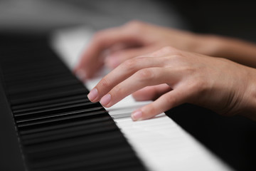 Sticker - Female hands playing on synthesizer, closeup