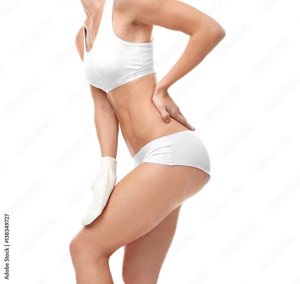 Young woman using exfoliating massage glove on white background