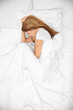 © Africa Studio - Young attractive woman sleeping in bed, top view