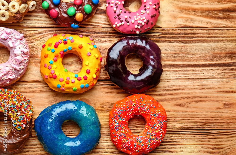 Glazed donuts on wooden background