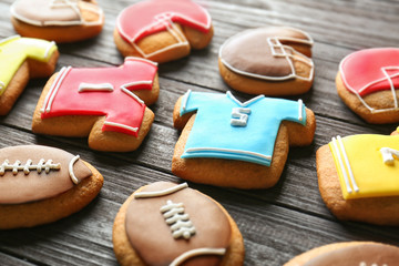 Poster - Tasty football cookies on wooden table, closeup