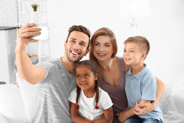 Canvas Print - Happy interracial family making selfie at home