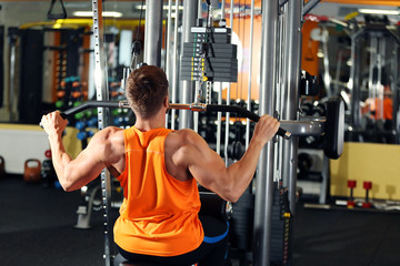 Wall Mural - Young man training in modern gym