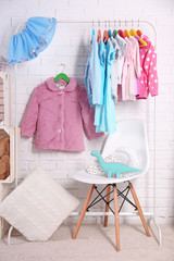 Wall Mural - Children clothing on hanger stand in dressing room