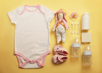 Wall Mural - Baby clothes and necessities on color background