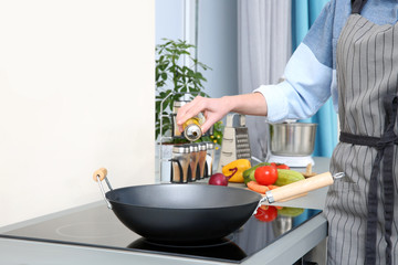 Sticker - Woman pouring oil in pan at kitchen