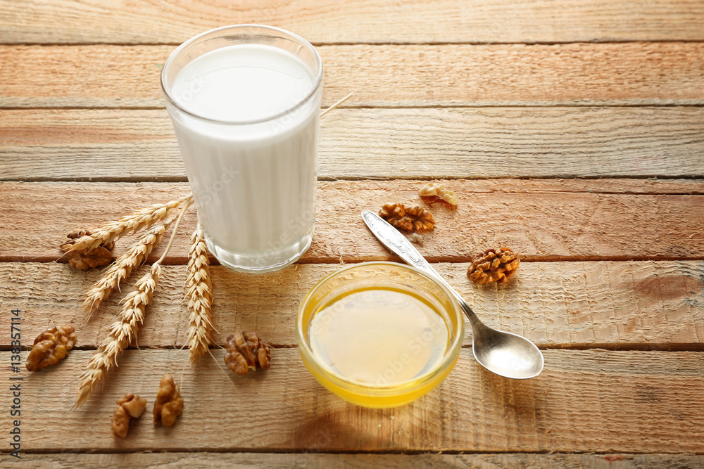 Composition with milk and honey on wooden background