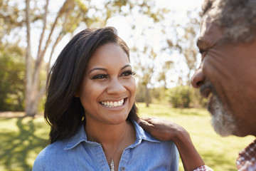 Wall Mural - Father And Adult Daughter Talking In Park Together