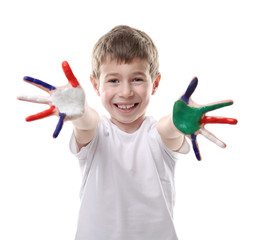 Little boy with hands in colorful paints isolated on white