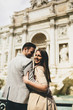 © BGStock72 - tourist couple on travel by Trevi Fountain in Rome, Italy.
