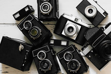 Vintage Backgroun With Collection Old Retro Photo Cameras. Top View, Medium Format