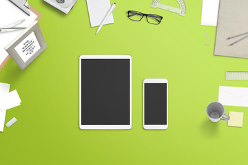 Poster - Tablet and smartphone with blank screen for mockup surrounded with stationery and office supplies. Top view off green desk.