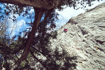 man climbs a rock