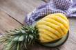 Pineapple on the plate on the wooden background
