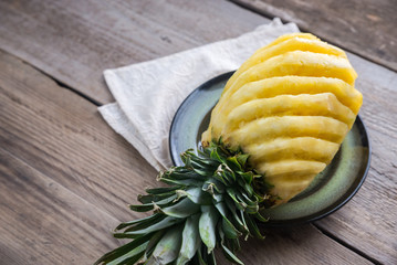 Poster - Pineapple on the plate on the wooden background