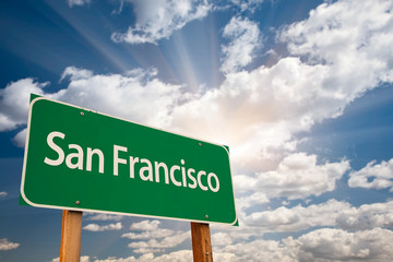 Wall Mural - San Francisco Green Road Sign Over Dramatic Clouds and Sky.