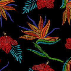 Wall Mural - Embroidery Bird of Paradise flowers, tropical Strelitzia, hibiscus seamless pattern. Vector fashion ornamental floral print on black background for fabric traditional folk decoration.