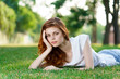 © SHOTPRIME STUDIO - pensive woman lies on the grass, support her head with her hand