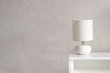 © FinchenkoInna - White Lamp on a commode. Grey background. Home concept