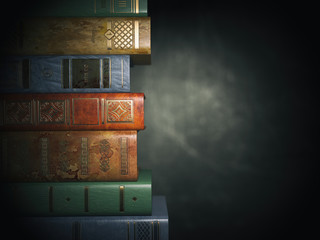 Poster - Vintage books on old  black dirty background.