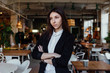 © photominus21 - Portrait of a young cute brunette girl business in the interior hipster cafes. Long hair.