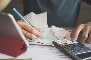 man using calculator for  calculate expenses accounts