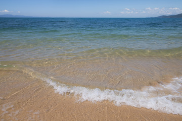 wave of blue sea on sandy beach. Background.