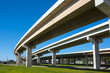 Highway overpass crossing neighborhood with a blue sky background