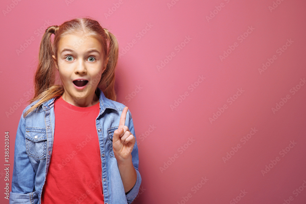 Emotional little girl on pink background