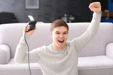 Canvas Print - Teenager playing videogame at home