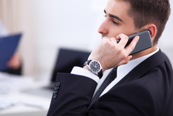 Business people talking on phone at office