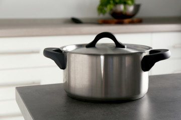 Wall Mural - Metal saucepan on table in kitchen