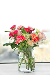 Sticker - Glass vase with beautiful bouquet of fresh flowers on windowsill