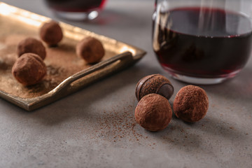 Red wine and chocolate truffles on table