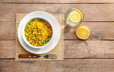 Wall Mural - Delicious rice with vegetables in a bowl on table