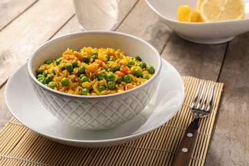 Wall Mural - Delicious rice with vegetables in a bowl on table