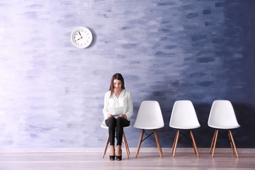 Wall Mural - Young woman waiting for job interview in reception hall